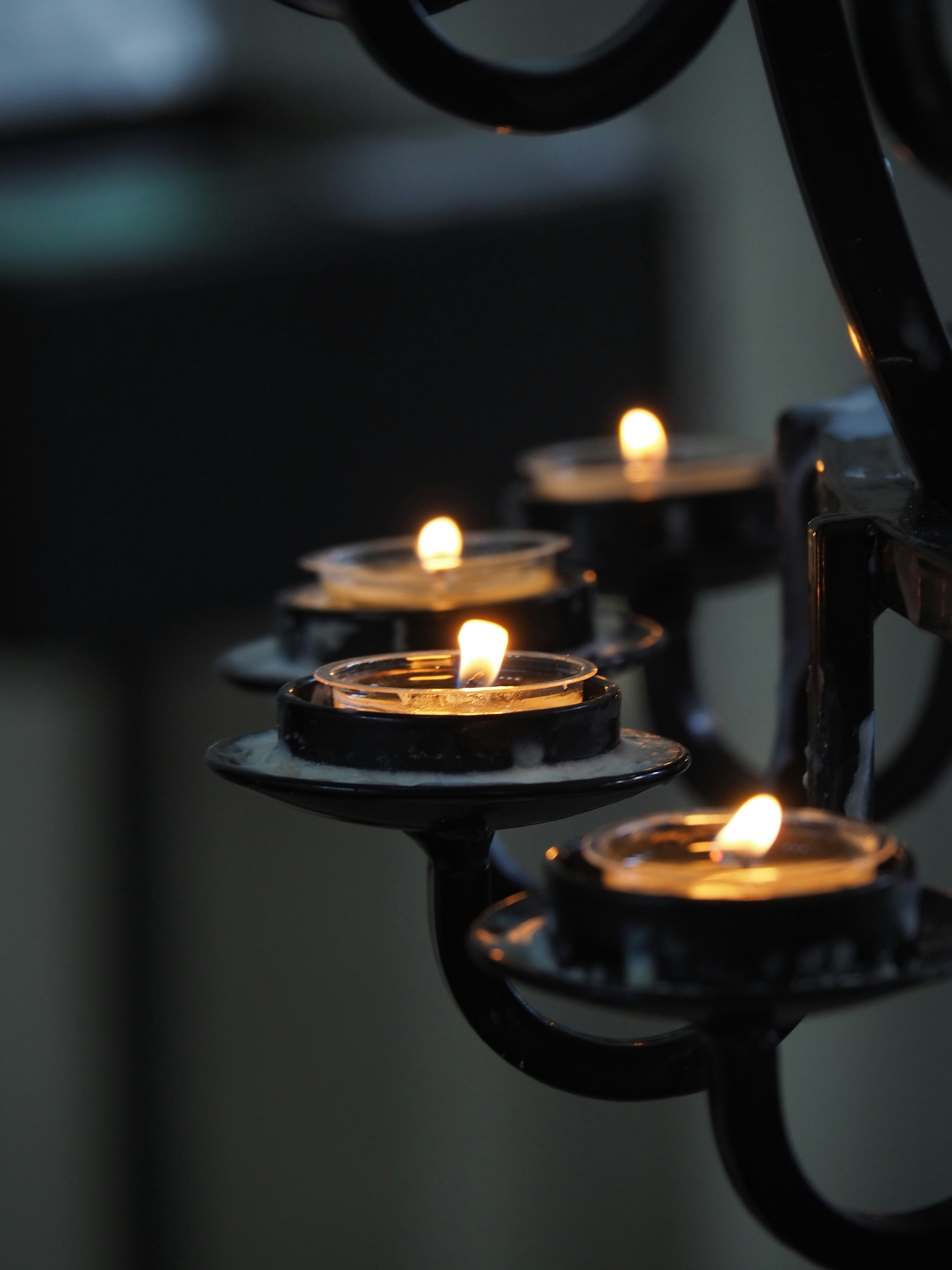 lighted candles on black metal candle holder